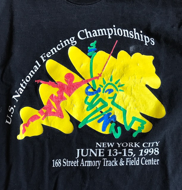 Closeup of Tshirt reading "U.S. National Fencing Championships, New York City, June 13-15, 1998, 168 Street Armory Track & Field Center."